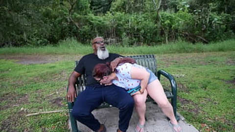 Nerdy Milf strokes and suck blk dick in the Park